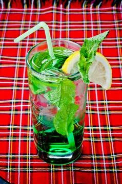 Mojito on a red background with lime 스톡 사진