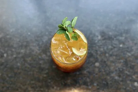 Mojito served in a bar background with lime slices, ice and mint leaves Stock Photos