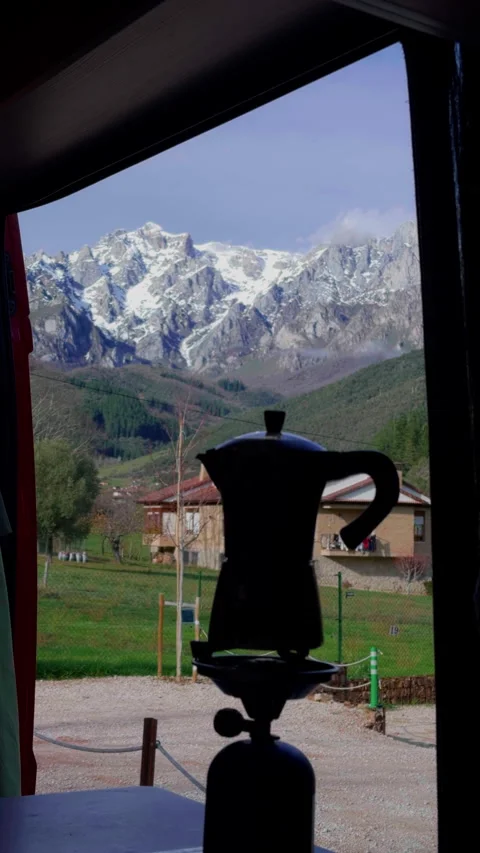 Moka pot brewing coffee inside campervan with mountain view vertical video Stock Footage 336632007