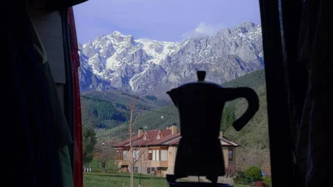 Moka pot brewing coffee inside campervan with alpine mountain landscape Stock Footage 336632101