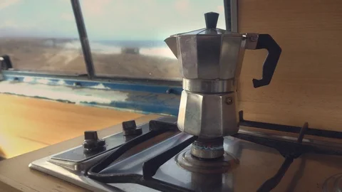 Moka pot coffee maker  on gas stove in a camper van. Cinemagraph. Looping movie. Stockbeeldmateriaal 104969983