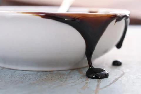 Molasses treacle in dish Stock Photos