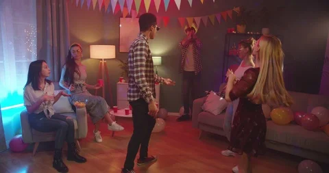 Molatto young guy dancing and Caucasian stylish guy sliding on the floor at that Stock Footage 122506118