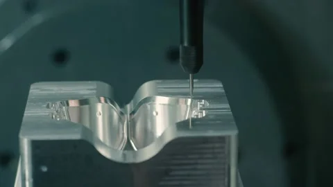 Mold machine drills and sprays water on mold as it's made in manufacturing plant Stock Footage 130668622