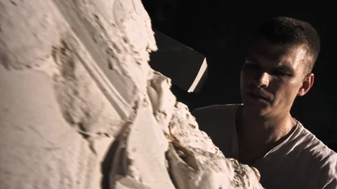 Mold maker use hammer with chisel to crack plaster mold before take off piece of Stock-Footage 130110115