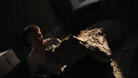 Mold maker use hammer with chisel to crack plaster mold before take off piece of Stock-Footage 130110374