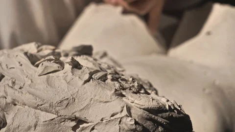 Mold maker use hammer with chisel to crack plaster mold before take off piece of Video stock 130110502