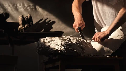 Mold maker use hammer with chisel to crack plaster mold before take off piece of Video stock 130110829