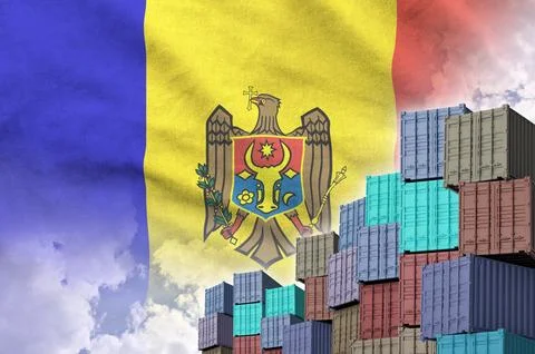 Moldova flag and big stack of shipping cargo containers in docks with sky Stock Photos