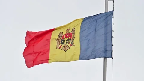 Moldova flag waving on tall silver pole against grey sky background. Stock Footage 339344127