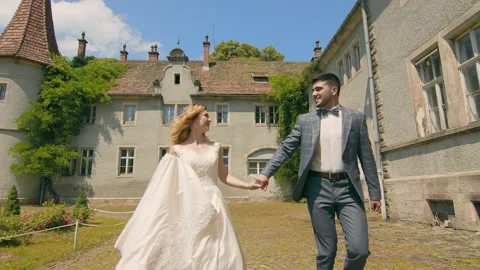 Moldovan couple running in slow motion holding hands on a sunny day. The Stock Footage 135223986