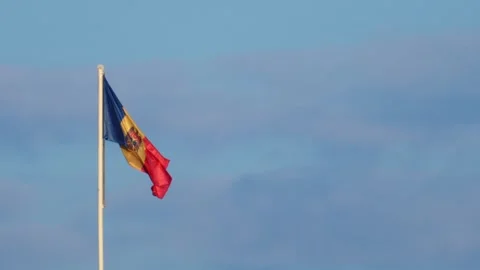 Moldovan flag waves proudly against clear blue sky, a symbol of national id.. Stock Footage 339755069
