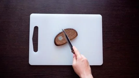Moldy bread on a cutting board. Stock Photos