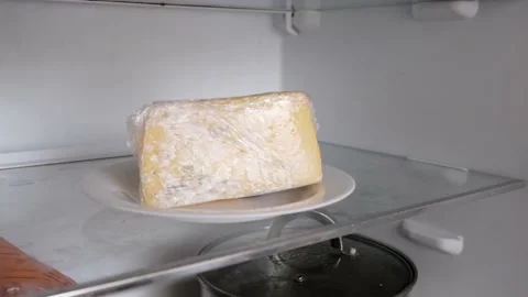 Moldy spoiled cheese in the refrigerator. Improper storage of food products. Stock Footage 151778610