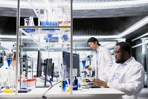 Molecular biologist uses computer program displaying DNA data analysis Stock Photos