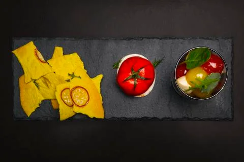 Molecular cuisine dish of vegetables on a rectangular black kamenny tray Foto stock