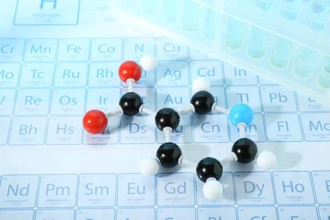 Molecular model and test tubes on periodic table Stock Photos