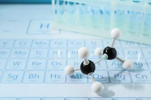 Molecular model and test tubes on periodic table Stockfoto's