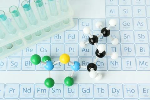 Molecular model and test tubes on periodic table, above view Stockfoto's