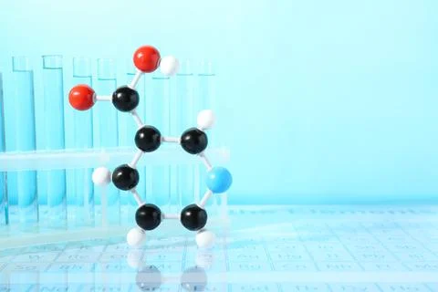 Molecular model and test tubes against light blue background, space for text Stock Photos