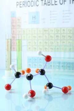 Molecular model on light surface against periodic table Stock Photos