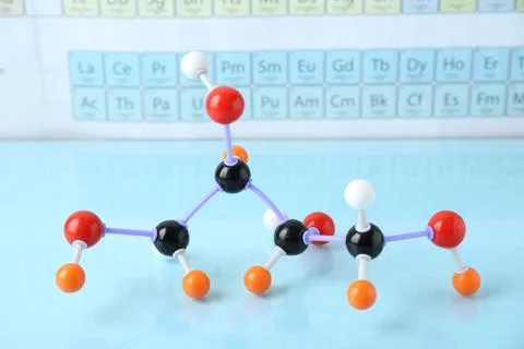 Molecular model on light surface against periodic table Stockfoto's