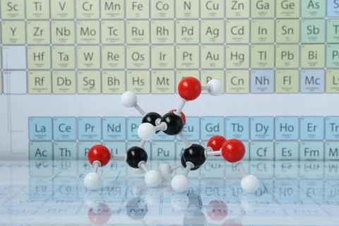 Molecular model on mirror surface against periodic table Stock Photos