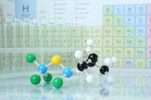 Molecular model on mirror surface against periodic table Stock Photos