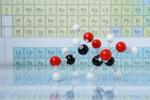 Molecular model on mirror surface against periodic table Stock Photos