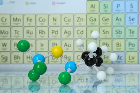 Molecular model on mirror surface against periodic table Stock Photos