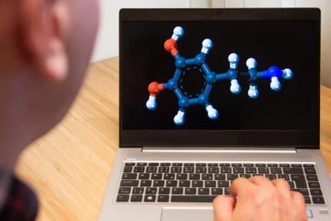 Molecular structure is analyzed by a chemist on the laptop. Microsoft customer Stock Photos