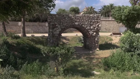 Molí de Mar arch beach coast Europe gate Medieval Mediterranean sea stone Stock Footage 317318979