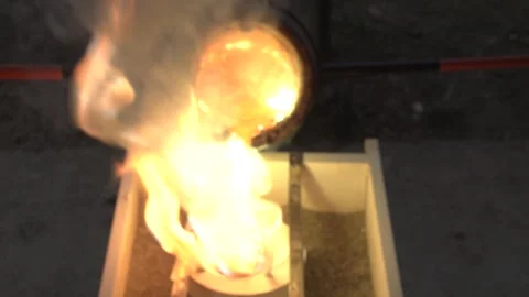 Molten bronze is poured into the mold Stock Footage 256038132