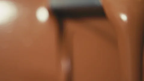 Molten chocolate running out of machine Stock Footage 274636164