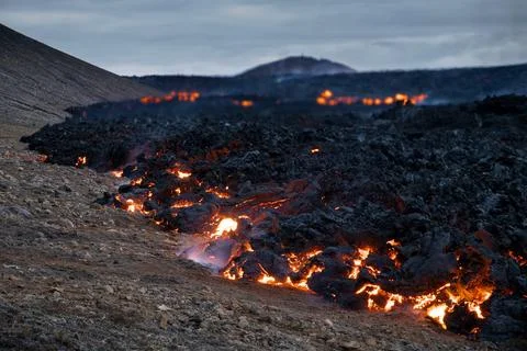 Molten lava flow during volcano eruption in Iceland Stock Photos