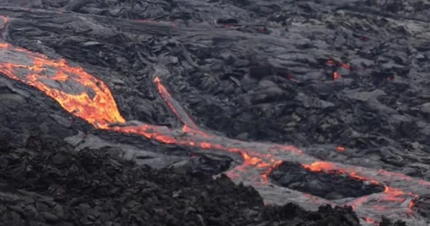 Molten lava flowing close up surface cold flow Hawaii Volcanoes magma Video stock 336579889
