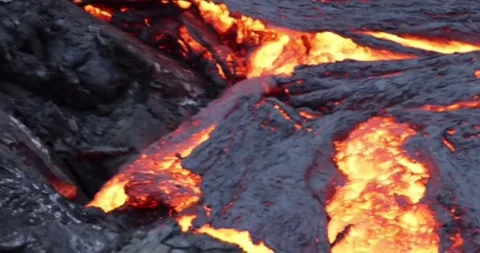 Molten lava flowing close up surface cold flow Hawaii Volcanoes magma Stock Footage 336580173