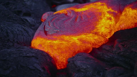 Molten lava flowing over volcanic rock Video stock 335498302