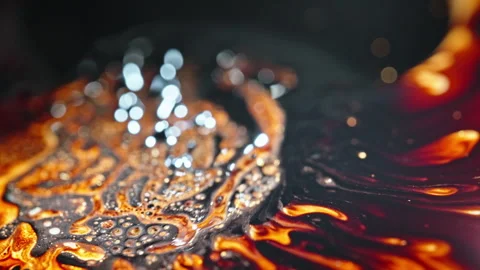 Molten liquid and magnetic elements blend together in a dynamic macro shot Stock Footage 288830409