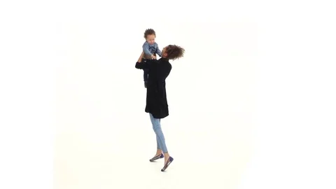 Mom of an african american throws her baby up, he likes it laughs. White Stock Footage 76751753