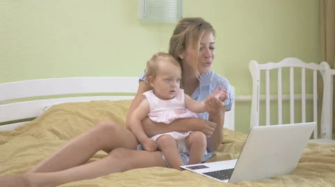 Mom and baby waving their a hands in the camera. Stock Footage