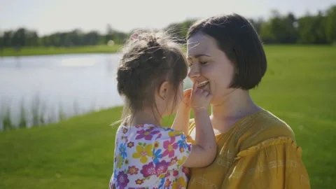 Mom and daughter cuddling kissing and sm... | Stock Video