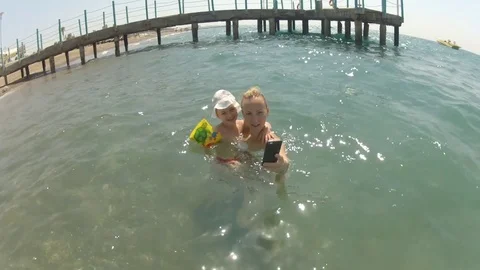 Mom and daughter do selfie in sea and ac... Stock Video Pond5