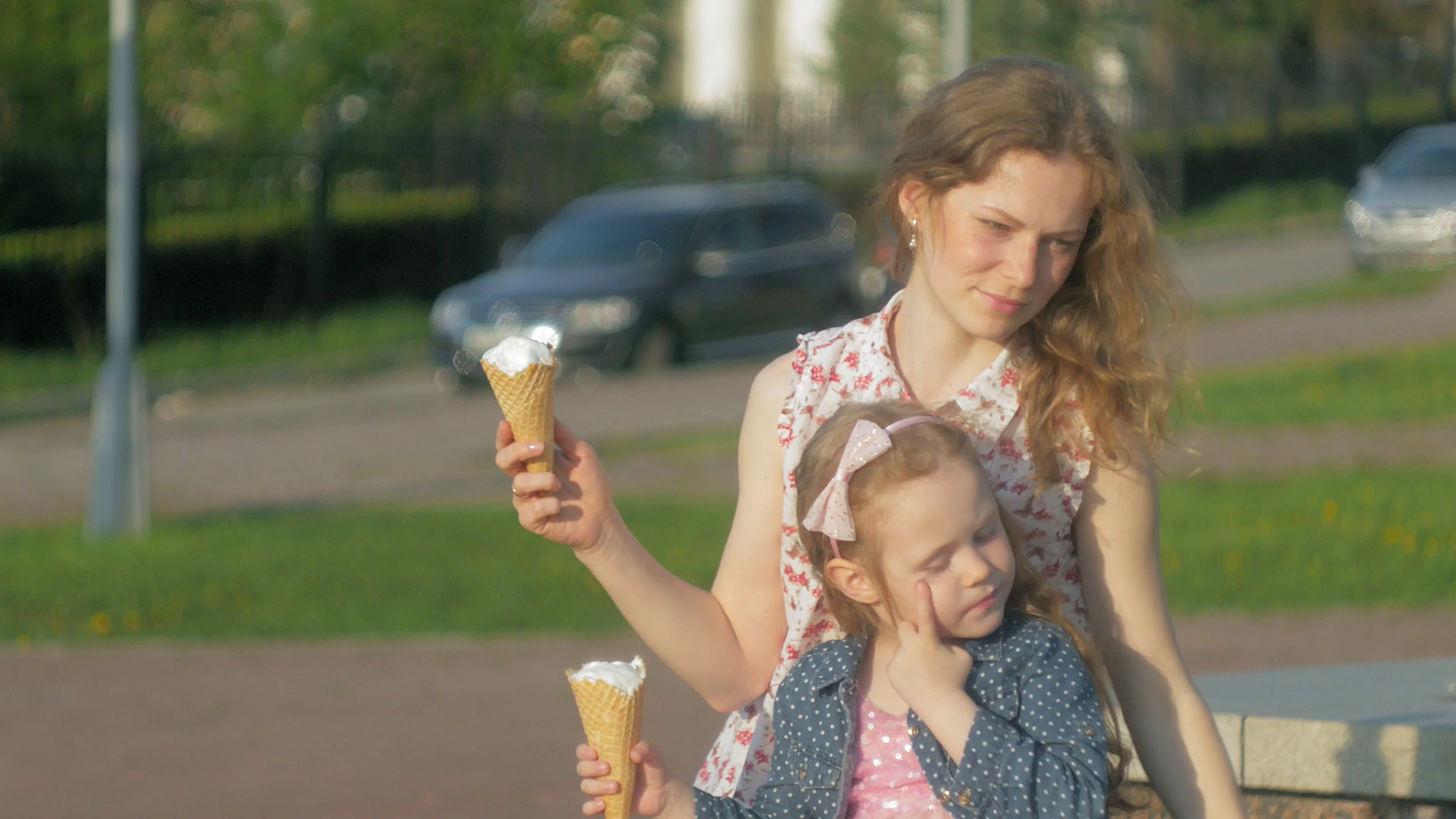 Mom and daughter eating ice cream in a park. mother and child. relaxing  happy