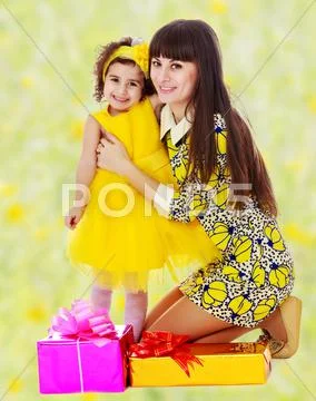 Mom and daughter with gifts in the New year Stock Photos