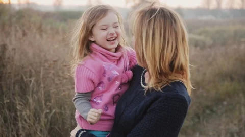 Mom and daughter in nature laugh and kis... | Stock Video 