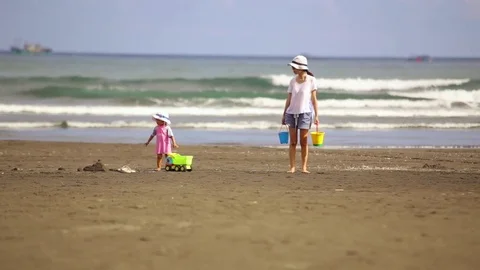 Mom and Daughter Playing and Walking on Beach Stock Footage