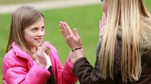 Mom and daughter playing clapping game Stock Footage 59554578