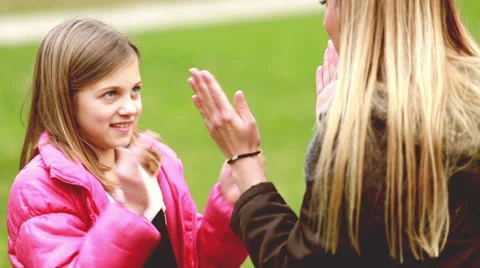 Mom and daughter playing clapping game Stock Footage 59554579