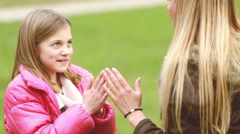 Mom and daughter playing clapping game Stock Footage 59554598